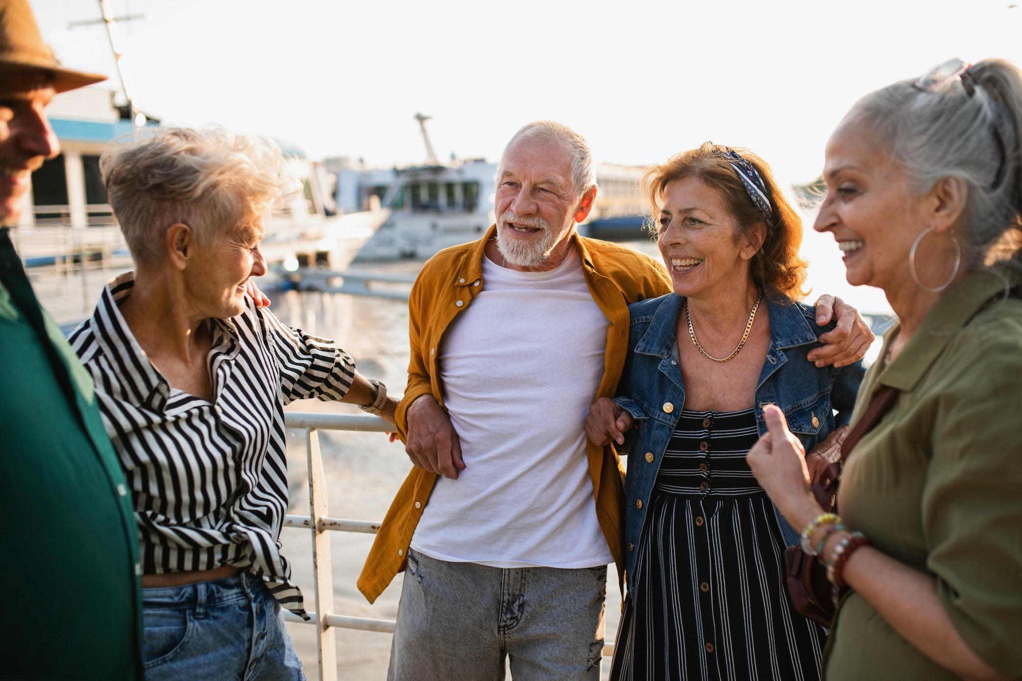 Group of people laughing and enjoying the sunset